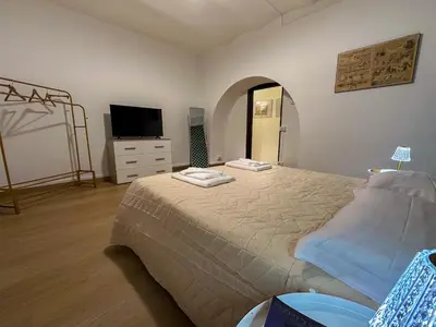 a bedroom with a bed and a tv on a dresser at Statilia 1 Apartment in Rome