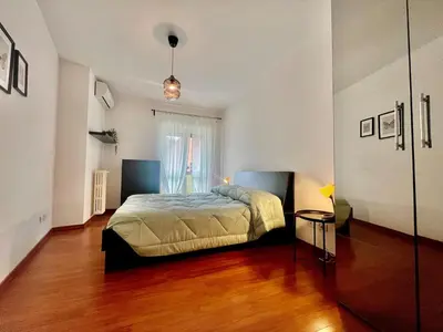 a bedroom with a bed and a wooden floor at Gandino House at Vatican in Rome