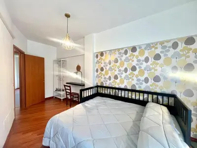 a bedroom with a large bed and a desk at Gandino House at Vatican in Rome