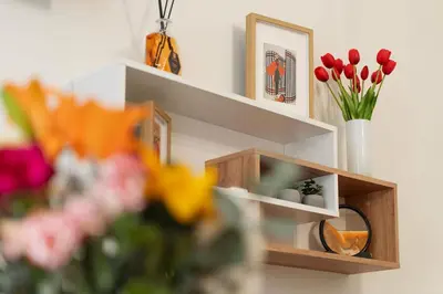 a shelf with flowers and a vase of flowers at PictaDomus-Albus, Metro Furio Camillo in Rome