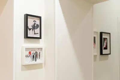a white wall with framed pictures on it at PictaDomus-Albus, Metro Furio Camillo in Rome