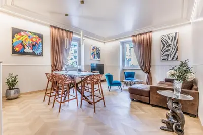 a living room with a table and chairs and a couch at Gianicolo Suites in Rome