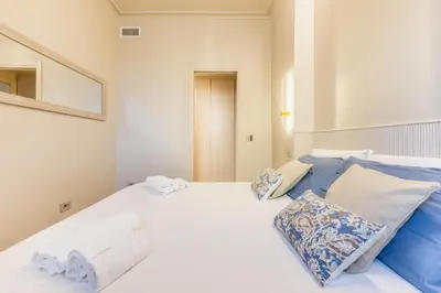 a bedroom with a large white bed with two pillows at Gianicolo Suites in Rome