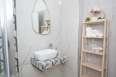 a bathroom with a sink and a mirror at Sunny's Suite - 8min from Colosseum in Rome