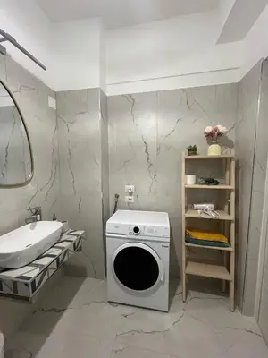 a bathroom with a washing machine and a sink at Sunny's Suite - 8min from Colosseum in Rome