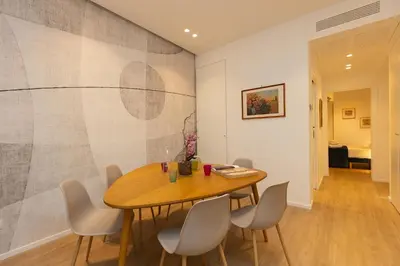 a dining room with a wooden table and chairs at Amazing Tacito in Rome