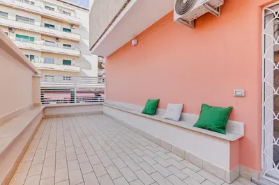 a balcony with green pillows on a building at Apartment Vatican with 2 bathrooms and terrace in Rome