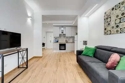 a living room with a couch and a kitchen at Apartment Vatican with 2 bathrooms and terrace in Rome