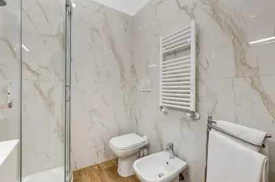 a white bathroom with a toilet and a sink at Apartment Vatican with 2 bathrooms and terrace in Rome