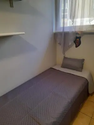 a small bed in a room with a window at LIAM condo in Rome