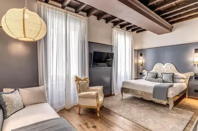 a bedroom with a bed and a chair and a couch at Telier Ripetta in Rome