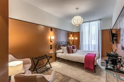 a hotel room with a bed and a tv at Telier Ripetta in Rome