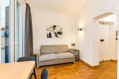 a living room with a couch and a table at La terrazza di Vanessa in Rome