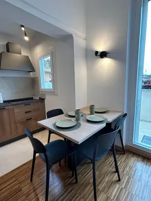 a dining room table with chairs and a kitchen at La terrazza di Vanessa in Rome