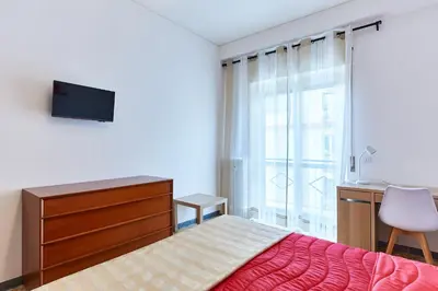 a bedroom with a bed and a dresser and a window at 15 minuti da San Giovanni - A c, Wifi e Smart Tv in Rome