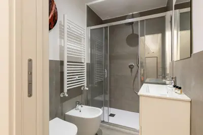 a bathroom with a toilet and a sink and a shower at Hostly-Puccini Luxury Home-Near Colosseum & Trevi in Rome