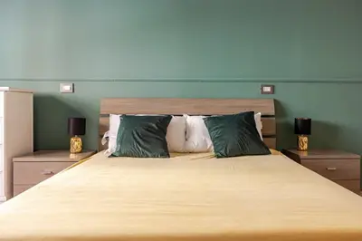 a bedroom with a large bed with two lamps at Dolce vita romana in Rome