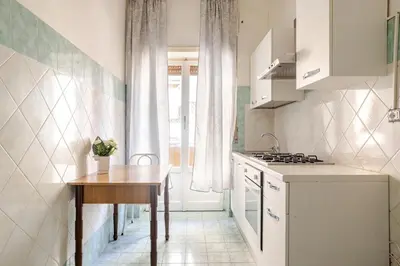 a kitchen with a wooden table and a table sidx sidx sidx at Dolce vita romana in Rome