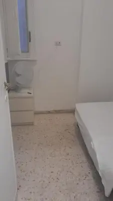 a white room with a bed and a toilet at Dolce vita romana in Rome