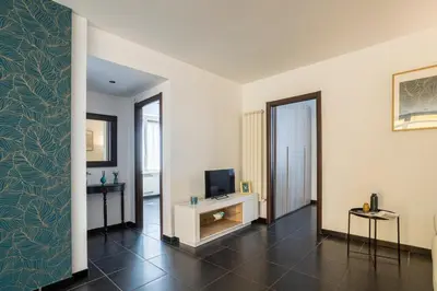 a living room with a television and a wall at Attico 4M - Ospedale Gemelli e Vista Panoramica by Hôtea in Rome