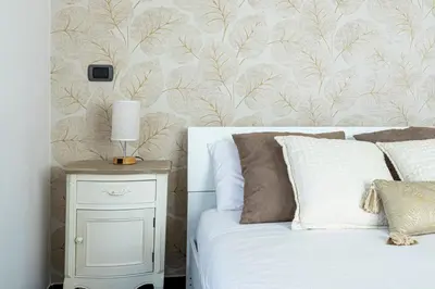 a bedroom with a bed and a night stand with a lamp at Attico 4M - Ospedale Gemelli e Vista Panoramica by Hôtea in Rome