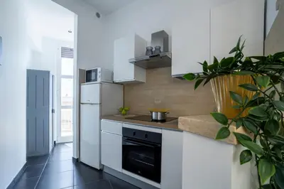 a kitchen with a stove and a refrigerator at Attico 4M - Ospedale Gemelli e Vista Panoramica by Hôtea in Rome