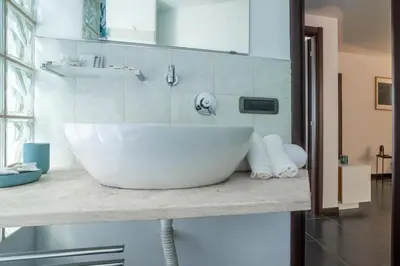 a bathroom with a large white sink on a counter at Attico 4M - Ospedale Gemelli e Vista Panoramica by Hôtea in Rome