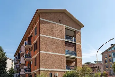 a brick building with balconies on the side of it at Brunetta Cozy Apartment-Metro B in Rome
