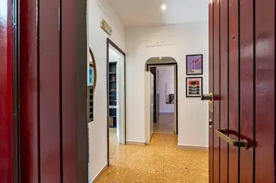 a hallway with a red door and a room with a hallway at Brunetta Cozy Apartment-Metro B in Rome