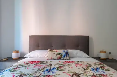 a bedroom with a large bed with a floral bedspread at Brunetta Cozy Apartment-Metro B in Rome