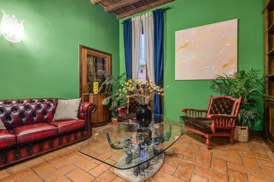 a living room with a couch and a glass table at Fico Giallo - Piazza Navona Apartment in Rome