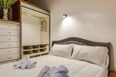 a bedroom with a bed with towels on it at Fico Giallo - Piazza Navona Apartment in Rome