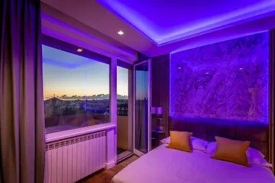 a purple room with a bed and a large window at Lyo Sky Rooms in Rome