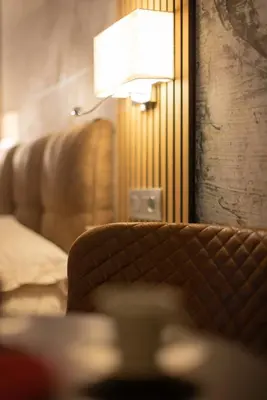 a living room with a couch and a lamp at Lyo Sky Rooms in Rome