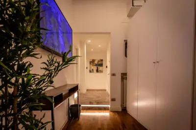 a hallway with white walls and a potted plant at Lyo Sky Rooms in Rome