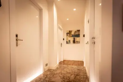 a hallway with white walls and a door at Lyo Sky Rooms in Rome