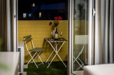 a small table with two chairs and a bottle of wine at Lyo Sky Rooms in Rome