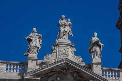 two statues on top of a building with a blue sky at Hotel Verona Rome in Rome
