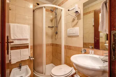 a bathroom with a shower and a toilet and a sink at Hotel Verona Rome in Rome
