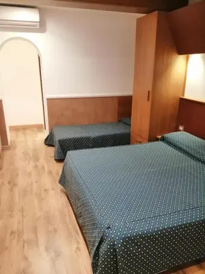 a room with four beds in a room at Hotel Verona Rome in Rome