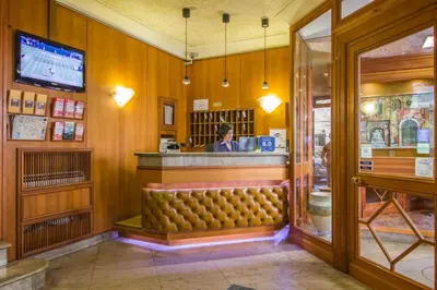 a woman sitting at the counter of a restaurant at Hotel Verona Rome in Rome