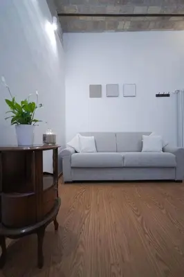 a living room with a couch and a table at Bruno Domus Colosseo in Rome