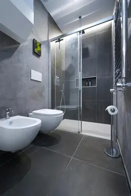 a bathroom with a shower and a toilet and a sink at Bruno Domus Colosseo in Rome