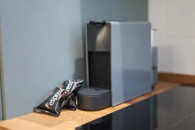 a television sitting on a shelf next to a bag of chips at Bruno Domus Colosseo in Rome