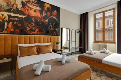 two beds in a room with a painting on the wall at ROME City Center Apartment III in Rome