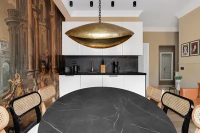 a dining room with a table and a gold pendant at ROME City Center Apartment III in Rome