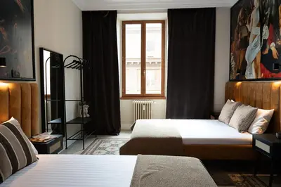 a hotel room with two beds and a window at ROME City Center Apartment III in Rome