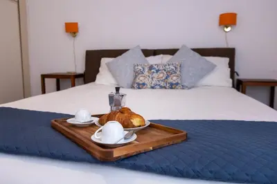 a tray with a loaf of bread on a bed at Centrale Attico vista Magnifica sul Vaticano in Rome