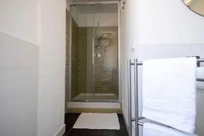 a bathroom with a shower with a glass door at Centrale Attico vista Magnifica sul Vaticano in Rome