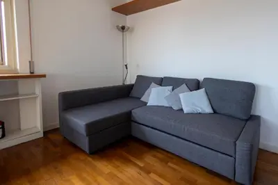 a gray couch with pillows in a living room at Centrale Attico vista Magnifica sul Vaticano in Rome